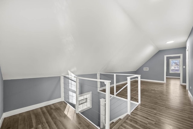 bonus room with lofted ceiling and dark hardwood / wood-style floors