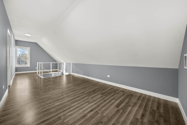 bonus room featuring lofted ceiling and dark hardwood / wood-style floors