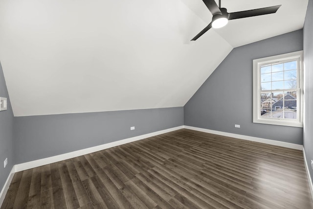 additional living space featuring dark hardwood / wood-style floors, ceiling fan, and lofted ceiling