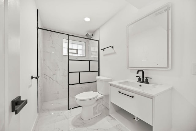 bathroom featuring vanity, a shower with shower door, and toilet