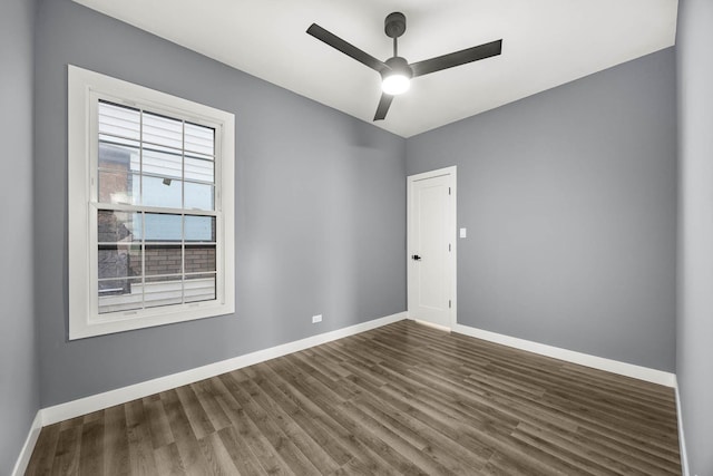 empty room featuring ceiling fan and dark hardwood / wood-style floors