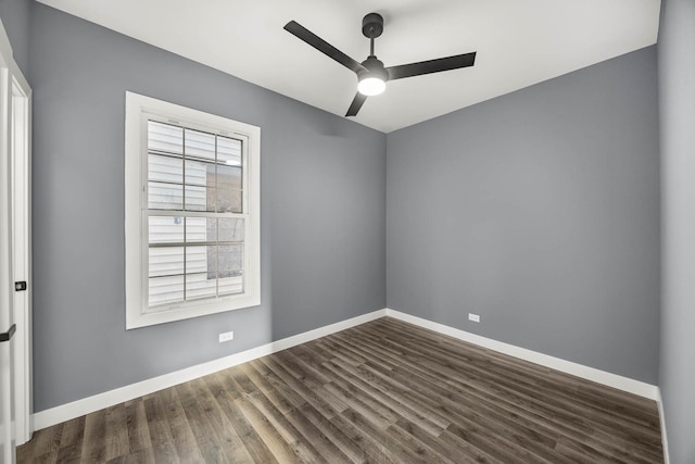 unfurnished room with ceiling fan and dark wood-type flooring