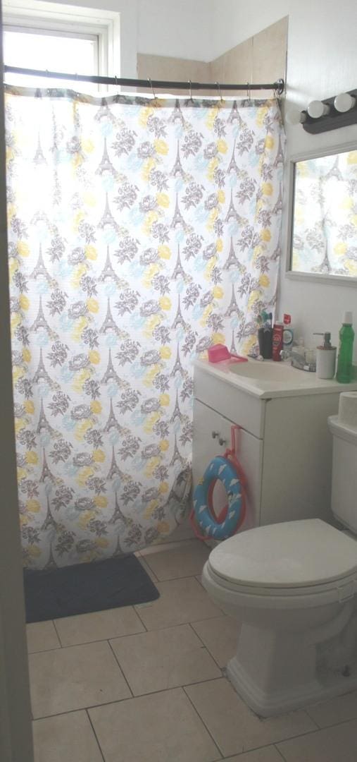 bathroom featuring tile patterned flooring and toilet