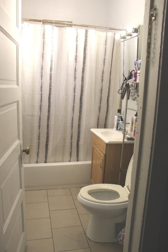 full bathroom featuring tile patterned flooring, shower / tub combo, vanity, and toilet