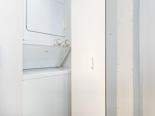 laundry area featuring stacked washer and clothes dryer