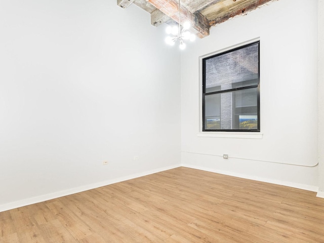 unfurnished room featuring a chandelier, beam ceiling, and light hardwood / wood-style floors