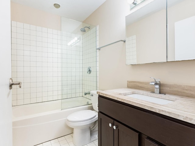 full bathroom with tile patterned flooring, tiled shower / bath combo, toilet, and vanity