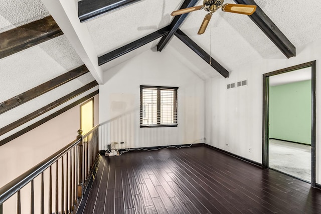 interior space featuring ceiling fan, lofted ceiling with beams, a textured ceiling, and wood-type flooring