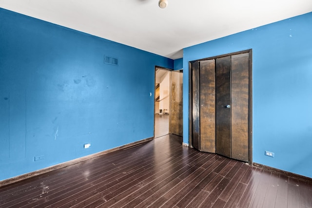 unfurnished bedroom featuring dark hardwood / wood-style flooring