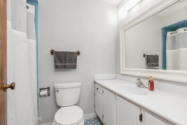 bathroom featuring tile patterned floors, vanity, and toilet