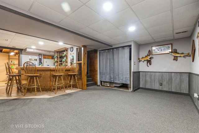 bar with a drop ceiling and carpet floors