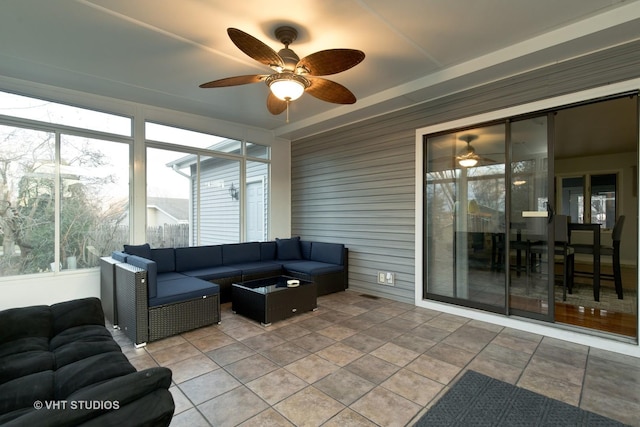 sunroom featuring ceiling fan