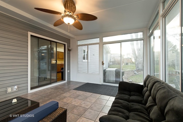 sunroom / solarium featuring ceiling fan