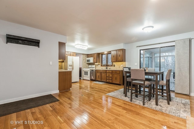 dining room with light hardwood / wood-style floors and sink