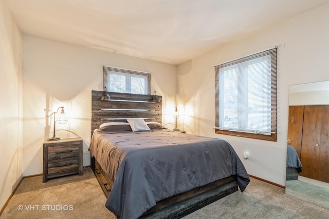 carpeted bedroom featuring multiple windows