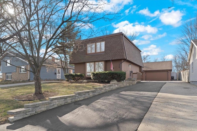 view of front of property featuring a garage and a front lawn