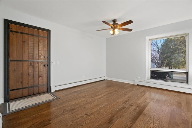 empty room featuring ceiling fan, hardwood / wood-style floors, and a baseboard heating unit