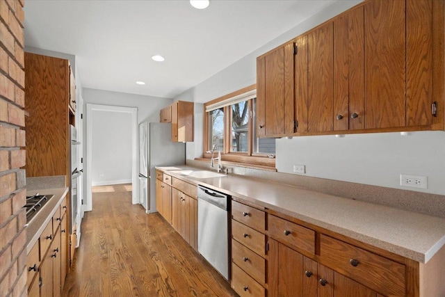 kitchen featuring sink, stainless steel appliances, and light hardwood / wood-style flooring