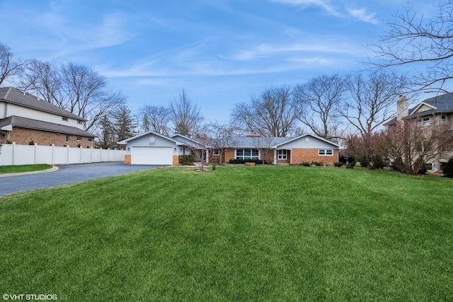 view of front of property with a garage and a front lawn