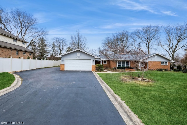 view of front of home with a front lawn and a garage