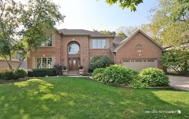 view of front of home featuring a front lawn and a garage