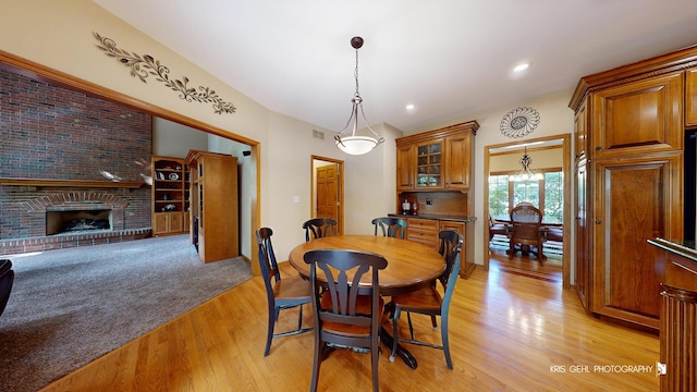 dining area featuring a fireplace and light hardwood / wood-style floors