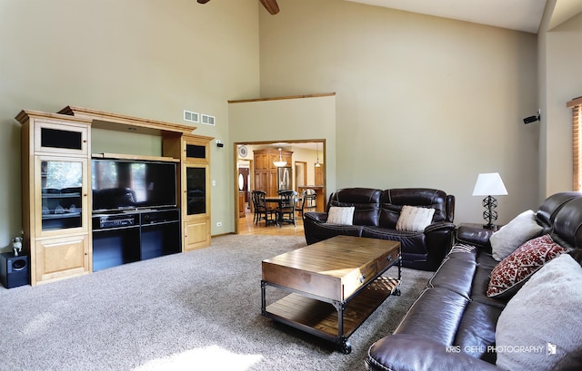 living room with high vaulted ceiling, ceiling fan, and carpet