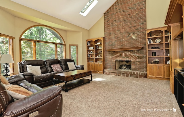 living room with high vaulted ceiling, a fireplace, a skylight, and light colored carpet