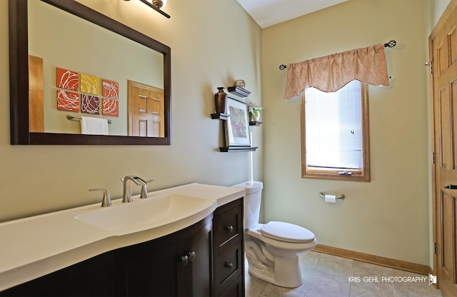 bathroom featuring tile patterned flooring, vanity, and toilet