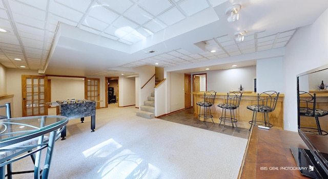 recreation room featuring bar and french doors