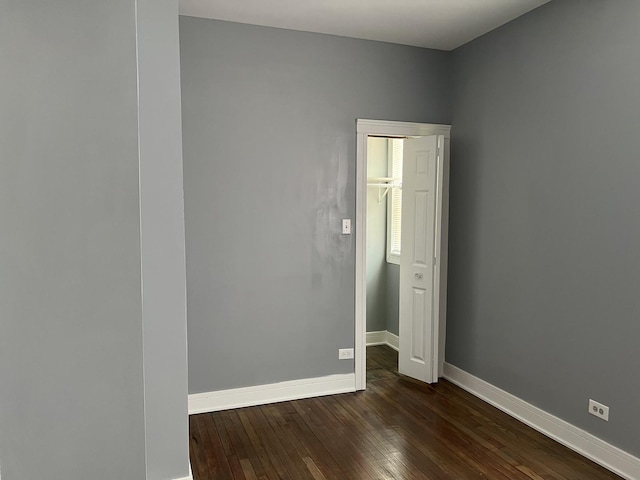 spare room with dark hardwood / wood-style floors