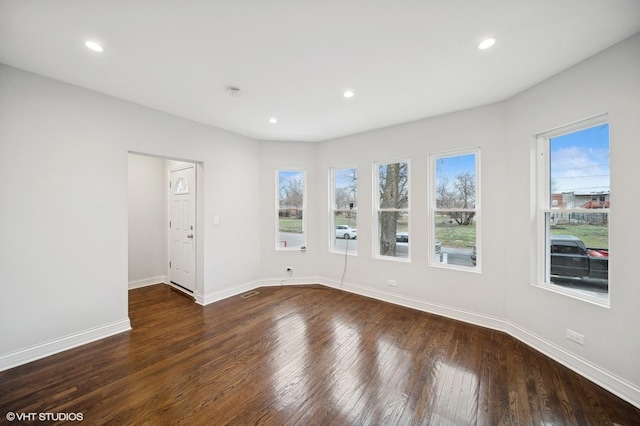 empty room with dark hardwood / wood-style floors