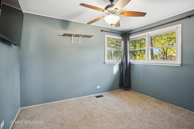 spare room featuring carpet flooring and ceiling fan