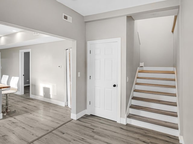 stairway with hardwood / wood-style floors