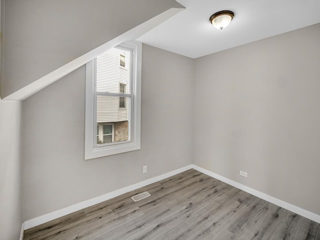 additional living space featuring light hardwood / wood-style floors