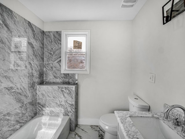 bathroom with a bathtub, vanity, and toilet