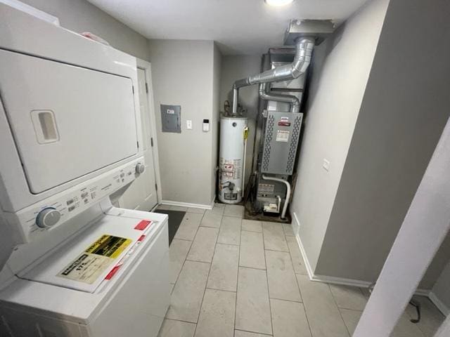 laundry area featuring gas water heater, laundry area, stacked washer / dryer, baseboards, and electric panel