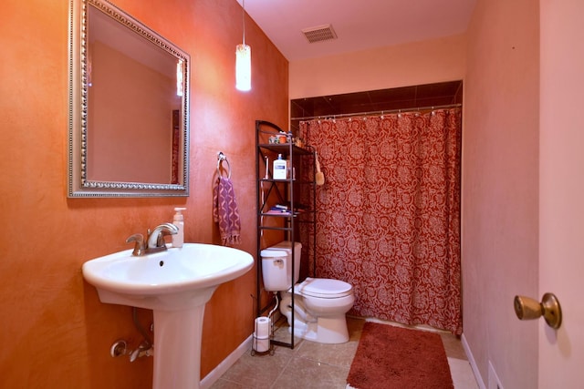 bathroom with tile patterned flooring, toilet, and a shower with shower curtain