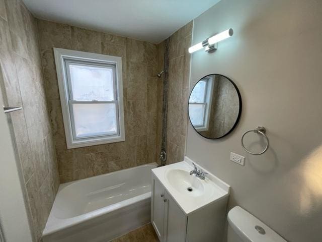 bathroom featuring toilet, shower / tub combination, and vanity