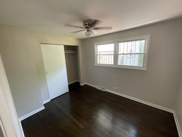 unfurnished bedroom with a closet, visible vents, and baseboards