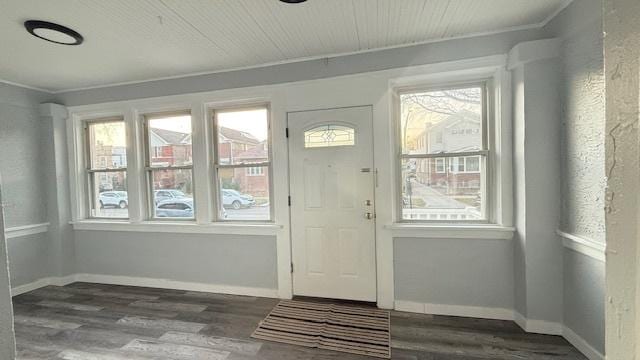 entryway with dark hardwood / wood-style flooring and ornamental molding