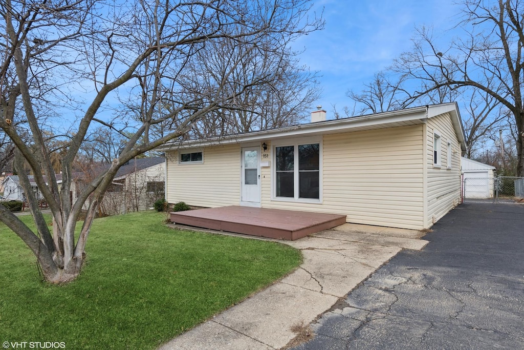 back of house with a wooden deck and a yard