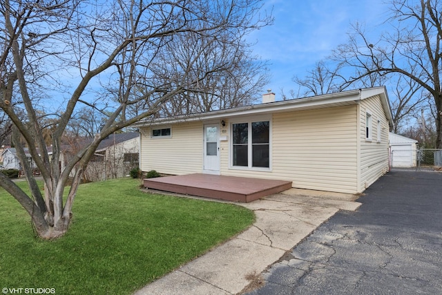 back of house with a wooden deck and a yard