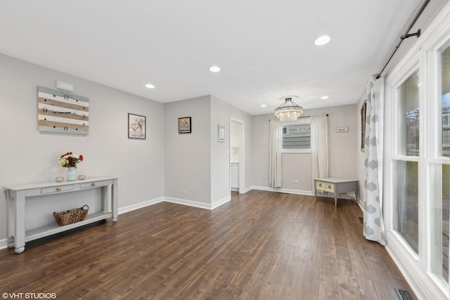 interior space featuring dark hardwood / wood-style floors and a notable chandelier