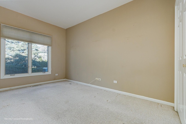 spare room featuring light colored carpet