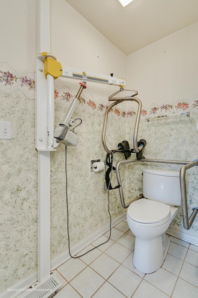 bathroom featuring tile patterned flooring, vaulted ceiling, and toilet