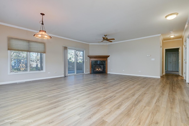 unfurnished living room featuring light wood-type flooring, ceiling fan, crown molding, and a premium fireplace