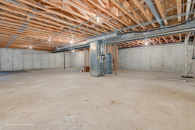 basement featuring heating unit and gas water heater