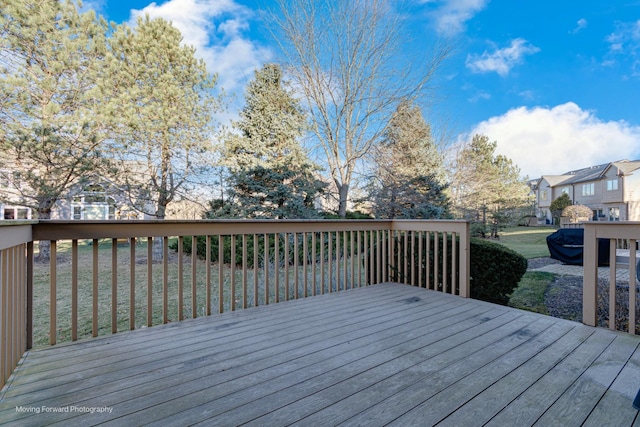 wooden terrace with a yard