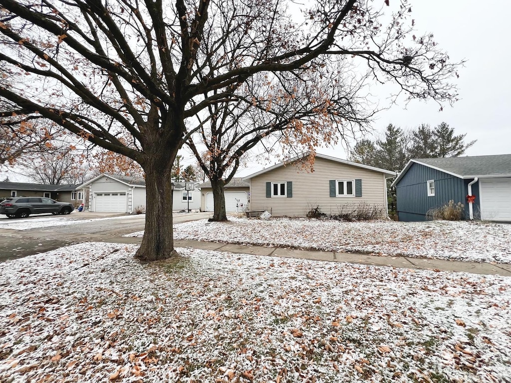 view of snow covered exterior with a garage